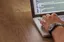 Notebook, charts, and a laptop on a desk used for IT service planning, ITSM best practices in Jira
