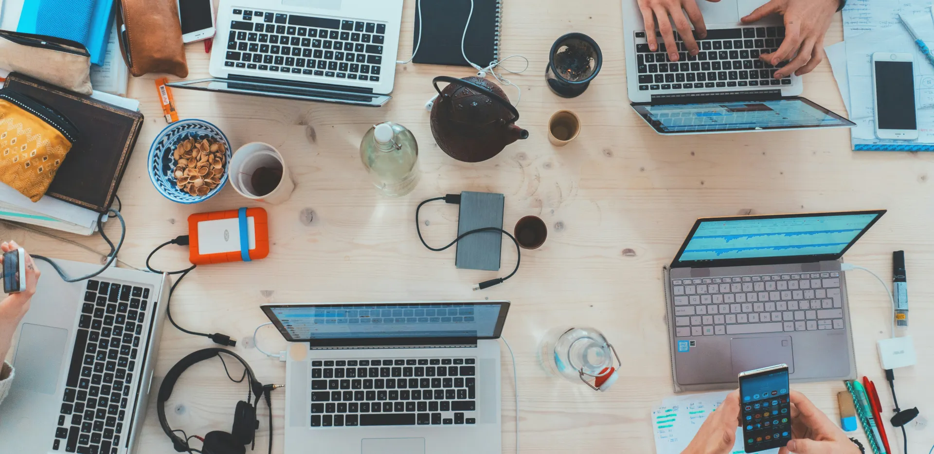 Developers collaborating around a laptop in a workspace, Jira best practices for software development teams