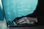 Developer working with code on a laptop, writing test cases in Jira